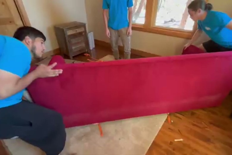 Carrying a sofa through the house